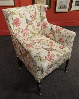 Lot 1411 - A George IV Mahogany Deep Armchair, with later exotic bird upholstery and cushion, on front...