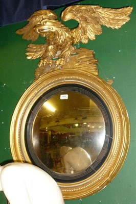 Lot 1415 - A Regency Style Gilt Convex Mirror, 19th century, the circular plate within a reeded slip and...