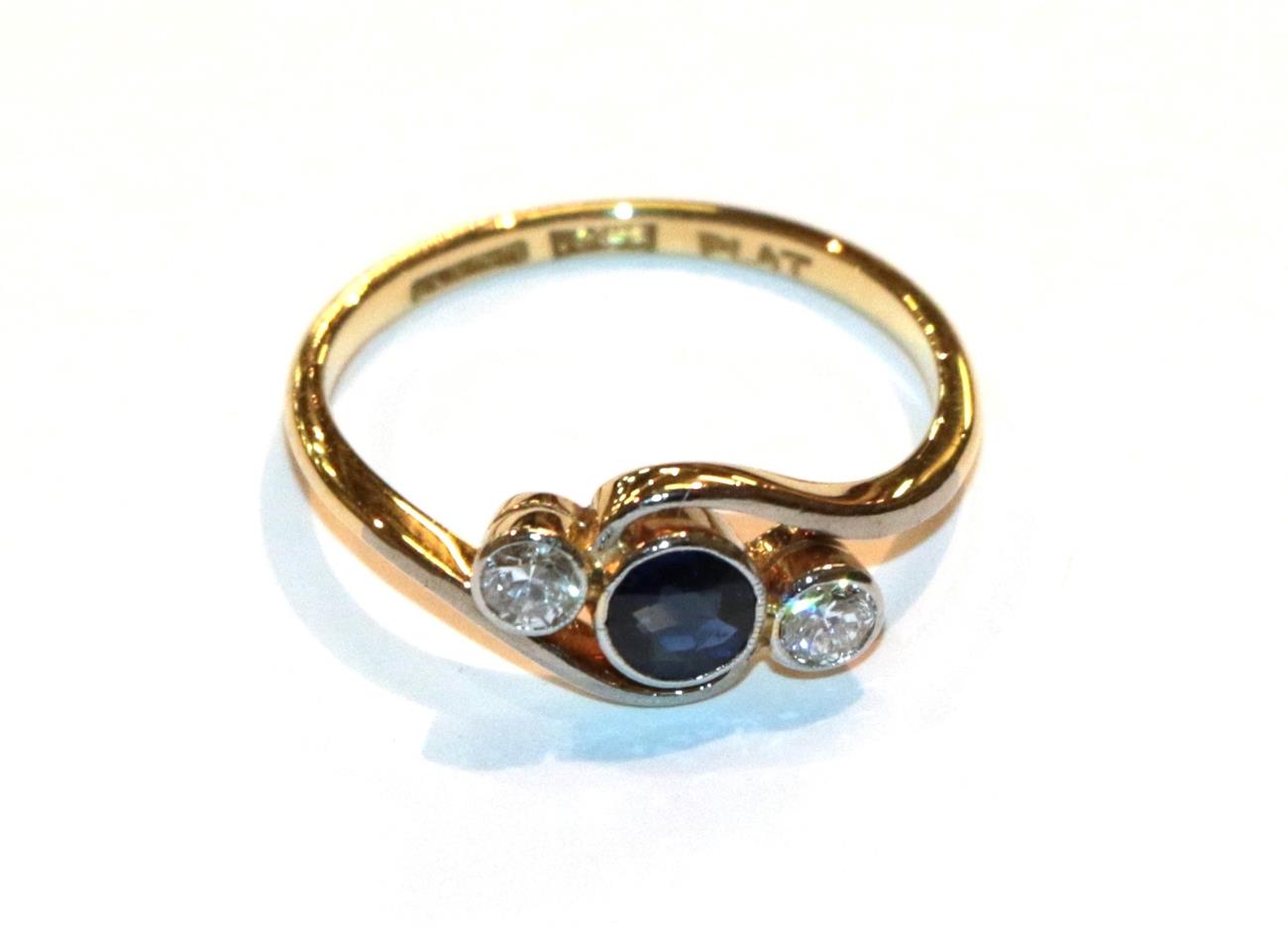 Lot 11 - A sapphire and diamond twist ring, stamped '18CT' and 'PLAT', finger size L1/2