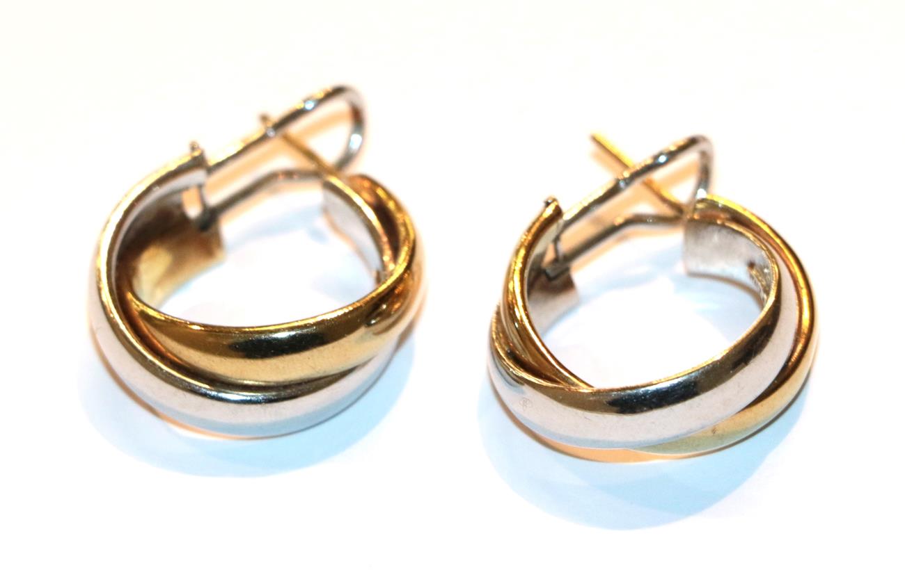 Lot 26 - A pair of bi-colour hoop earrings, stamped '9KT', with post and clip fittings
