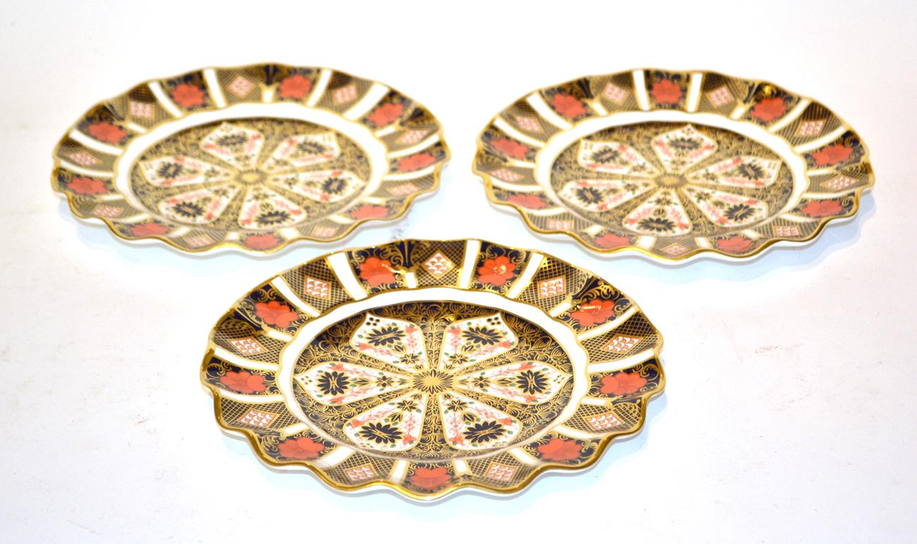 Lot 52 - Three Royal Crown Derby Imari palette scallop edged plates, 22cm diameter