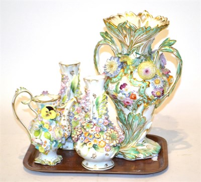 Lot 67 - A 19th century flower encrusted twin-handled vase, 23cm high, together with a pair of flower...