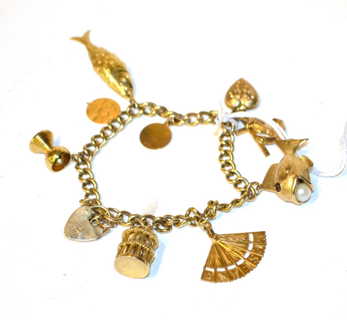 Lot 106 - A charm bracelet with 9 carat gold padlock clasp (marks rubbed) hung with various charms...