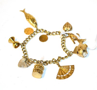 Lot 106 - A charm bracelet with 9 carat gold padlock clasp (marks rubbed) hung with various charms...