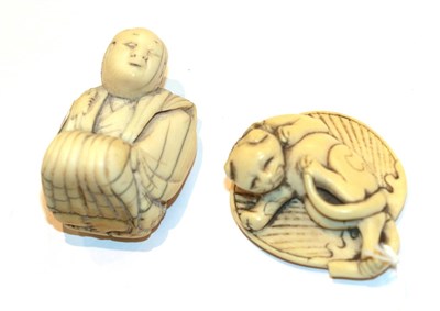 Lot 119 - Japanese ivory netsuke, cat on a leaf, 4.5cm wide; and another as a kneeling man, 4.3cm high (2)