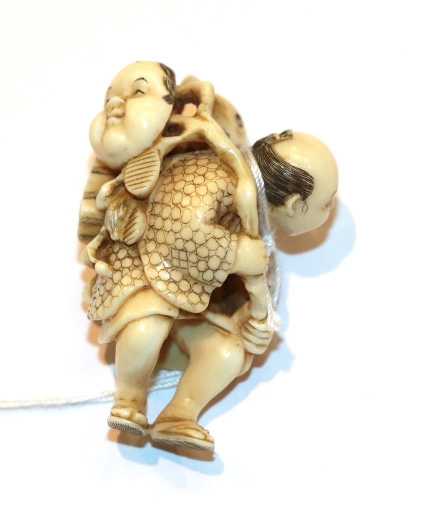 Lot 125 - Japanese ivory netsuke, fisherman with fish and mask, 4.5cm high