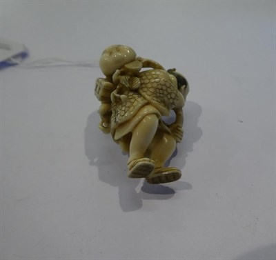 Lot 125 - Japanese ivory netsuke, fisherman with fish and mask, 4.5cm high