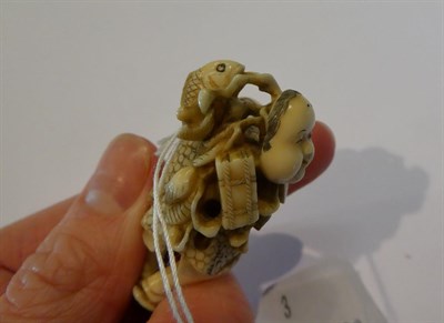 Lot 125 - Japanese ivory netsuke, fisherman with fish and mask, 4.5cm high