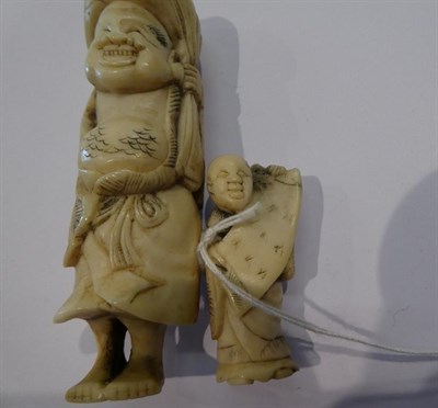 Lot 127 - Japanese ivory netsuke, foreigner and boy, 7.5cm high