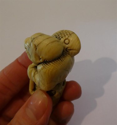 Lot 128 - Japanese ivory netsuke, figure with fish, 7cm high