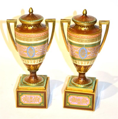 Lot 188 - A pair of Vienna urn shaped vases and covers, raised on plinths (one a.f.), 23cm high...