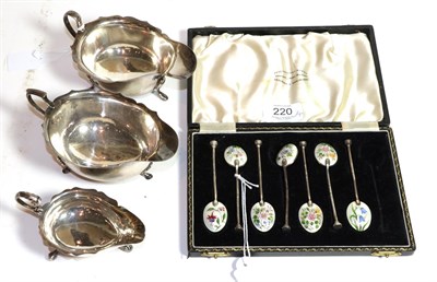 Lot 220 - A set of seven George VI silver and enamel teaspoons, the bowl of each spoon enamelled with a...