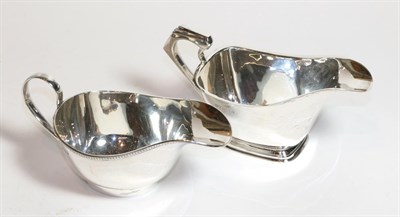 Lot 225 - Two George V silver sauceboats, the first by Thomas Fattorini, Birmingham, 1934, oblong and on...