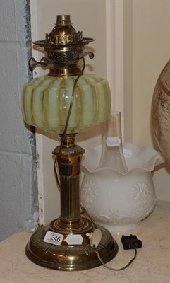 Lot 246 - A Victorian oil lamp, opaque shade, iridescent striped glass reservoir, gilt brass base