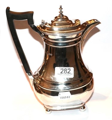 Lot 282 - A George V silver hot-water jug, Retailed by Harrods, Sheffield, 1934, baluster and on four...