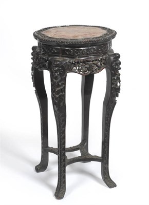 Lot 1451 - An Early 20th Century Carved Chinese Hardwood Plant Stand, with pink marble top within a flower...