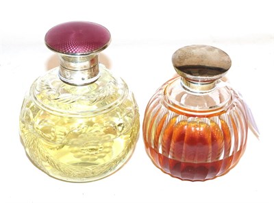 Lot 301 - Two silver topped cut glass scent bottles, the first Albert Carter, Birmingham, 1926, the body...