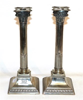 Lot 302 - A pair of silver plated Corinthian column candlesticks with sconces, stamped WMFN, 31cm high