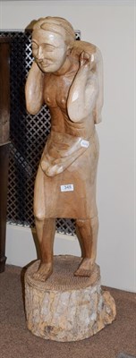 Lot 348 - A large Sri-Lankan hardwood carving of a traditional figure, 106cm high