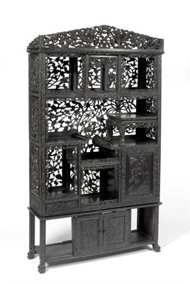 Lot 1457 - A Chinese Padouk Wood Display Cabinet, late 19th century, foliate carved depicting Chinese dragons