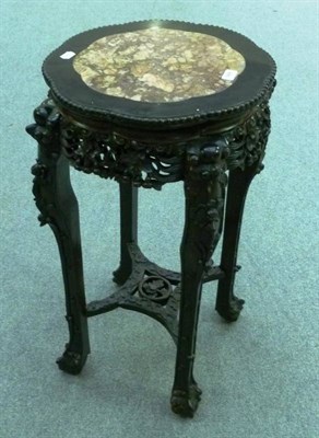 Lot 1458 - A Chinese Carved Hardwood Plant Stand, early 20th century, inset pink marble top above a...