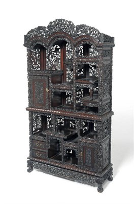 Lot 1459 - An Impressive Chinese Carved Hardwood Display Cabinet, late 19th century, richly decorated with...