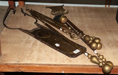 Lot 411 - A set of three brass fire tools, three individual fire tools and an Arts & Crafts wall plaque