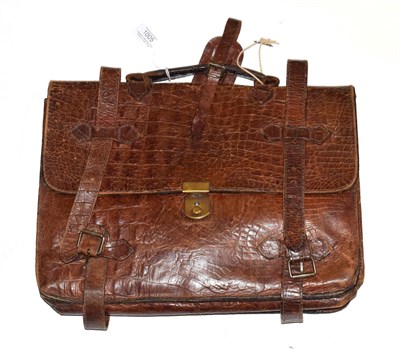 Lot 1005 - Brown crocodile briefcase, with modern lined and named lining, leather straps with buckles, padlock