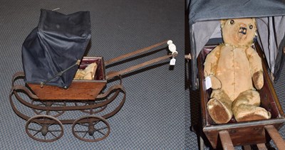 Lot 1026 - Early 20th century wooden dolls pram with hood and jointed teddy bear (2)