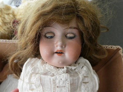 Lot 1027 - Wax head doll (a.f.), another smaller with blue eyes and a bisque head doll