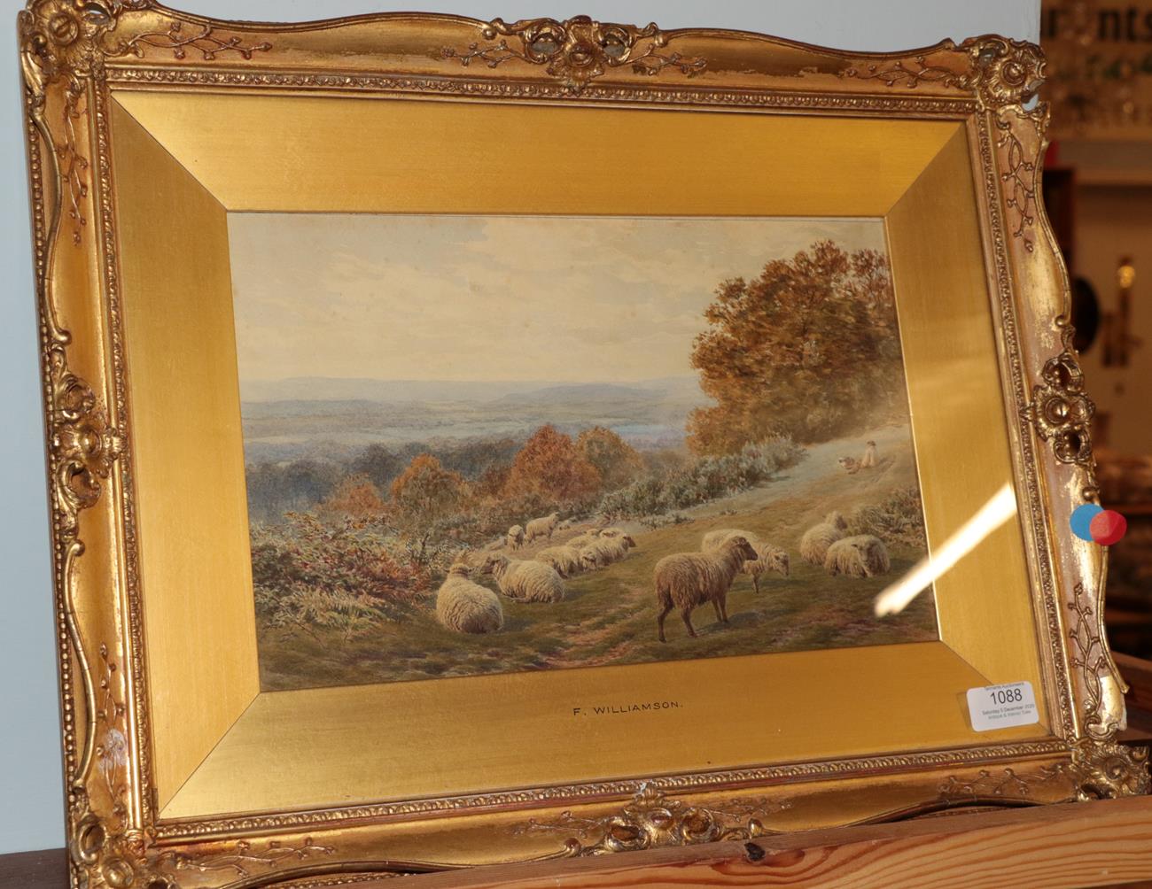 Lot 1088 - Frederick Williamson (1833-1900) Shepherd at rest beside his flock, in an extensive landscape,...