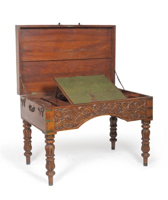 Lot 1480 - A Mid 19th Century Colonial Carved Hardwood and Brass Bound Desk, probably South Indian, the hinged