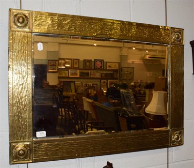 Lot 1172 - A Scottish Arts & Crafts brass framed mirror, 87cm by 62cm