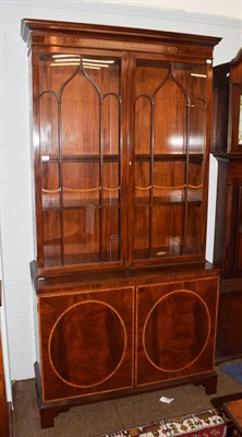 Lot 1175 - A Georgian style mahogany and satinwood banded bookcase, moulded cornice above twin glazed...