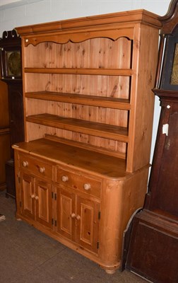 Lot 1185 - A 20th century pine dresser, moulded cornice above three shelves, base with two drawers above...