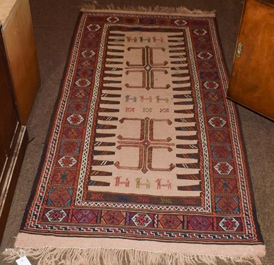 Lot 1196 - Baluch flatweave rug, the camel field of zoomorphic and geometric devices enclosed by...