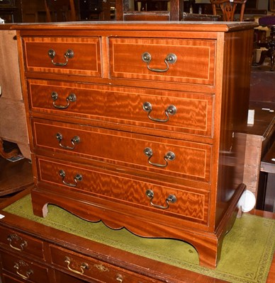 Lot 1204 - A Georgian style mahogany and crossbanded chest of drawers, two short over three long drawers,...