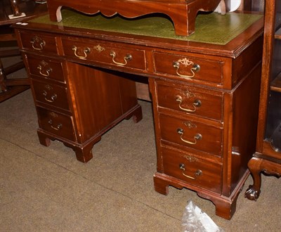 Lot 1205 - A 20th century mahogany twin-pedestal desk, green leather inset, arrangement of nine drawers,...