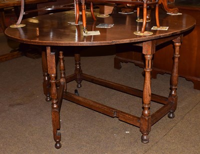 Lot 1207 - An early 19th century oak gate-leg dining table, 148cm by 123cm by 73cm high