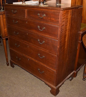 Lot 1208 - A George III Provincial oak chest of drawers, two short over four long graduated drawers, on...