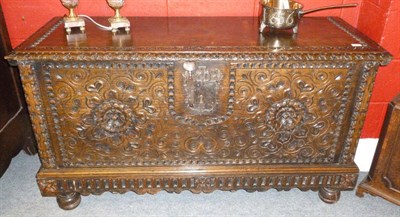 Lot 1485 - A Continental Chestnut Coffer, the rectangular lid deeply chip carved and with foliate carved edge