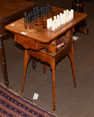 Lot 1229 - A 19th century oak games table with an inlaid top, on square tapered legs, 60cm by 39cm by 72cm...