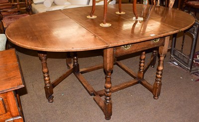 Lot 1234 - A Titchmarsh & Goodwin style oak drop-leaf dining table fitted with two drawers, 187cm (open)...