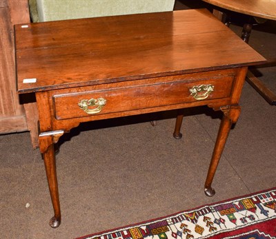 Lot 1235 - An 18th century oak side table, rectangular top above single drawer, brass swan neck handles,...