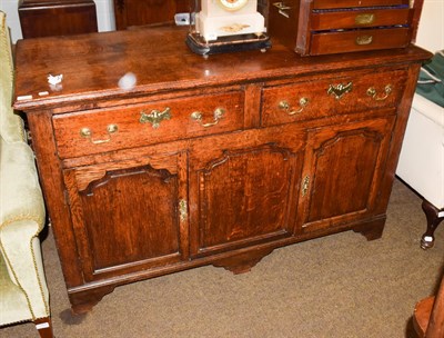 Lot 1241 - An 18th century oak enclosed low dresser, moulded rectangular top, two drawers, brass swan neck...