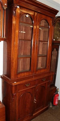 Lot 1263 - A Victorian walnut bookcase, moulded cornice above twin arched glazed doors, the base with twin...