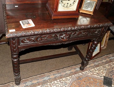 Lot 1269 - A Victorian Neo-Gothic oak side table with swan neck pediment back, single drawer and bobbin turned