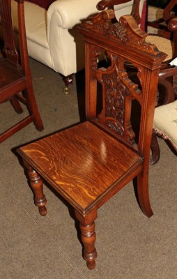 Lot 1277 - A 19th century hall chair, broken-swan-neck crest rail, pierced and carved back, plank seat, turned