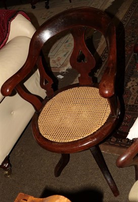 Lot 1280 - A 19th century caned seat swivel chair bearing label 'Matthews & Co. Gloucester'
