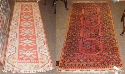 Lot 1282 - A Melas runner, the terracotta field of stylised flowers enclosed by borders of angular...